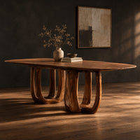 Oval dining table on two pedestal bases with tall arched openings, three-quarter view showing the grain
