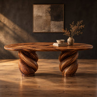 Oval dining table with two twisted rope pedestal bases in a dark studio against a charcoal plaster wall