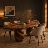 Oval dining table with two twisted rope pedestal bases in a dark dining room at golden hour