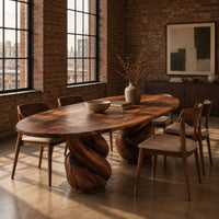 Oval dining table with two twisted rope pedestal bases in an industrial loft dining room with exposed brick