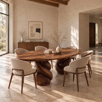Oval dining table with two twisted rope pedestal bases in a bright open plan dining room