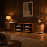 Oval ended tv stand with four open cubbies between two end cabinets in an evening living room with walnut wall paneling