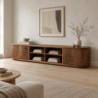 Oval ended tv stand with four open cubbies between two end cabinets in a Scandinavian living room with white walls