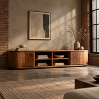 Oval ended tv stand with four open cubbies between two end cabinets in an industrial loft living room with exposed brick
