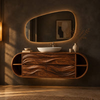 Oval floating cabinet with four carved wave panels and open end shelves in a dark bathroom at golden hour