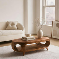 Oval porthole coffee table with a low shelf in a bright modern living room