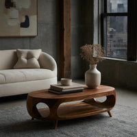 Oval porthole coffee table with a low shelf in a concrete and timber loft