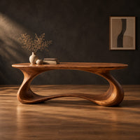 Oval top desk on one continuous ribbon loop base with an open center in a dark studio against a charcoal plaster wall