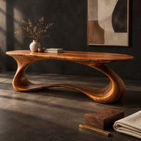 Corner detail of oval top desk on one continuous ribbon loop base with an open center beside wood, brass and linen samples