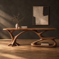 Oval top desk on branching legs with a low loop tier in a dark studio against a charcoal plaster wall