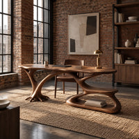Oval top desk on branching legs with a low loop tier in an industrial loft home office with exposed brick