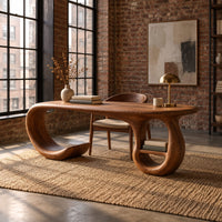 Oval top wooden desk with an open sweeping leg and a ring shaped base in an industrial loft home office with exposed brick
