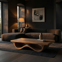 Pale hardwood coffee table with an undulating base in a living room at golden hour