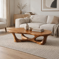 Pebble shaped coffee table on branching legs with open arches in a Scandinavian living room with white walls
