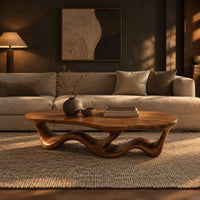 Pebble shaped coffee table with a rippling open ribbon base in a dark living room at golden hour