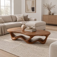 Pebble shaped coffee table with a rippling open ribbon base in a Scandinavian living room with white walls