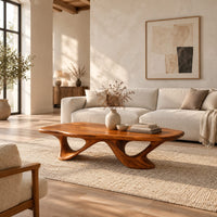 Pebble shaped coffee table with sweeping arched legs in a bright open plan living room