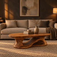 Oval coffee table on a heavy pedestal with a swirling hollow in a dark living room at golden hour