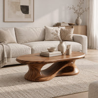 Oval coffee table on a heavy pedestal with a swirling hollow in a Scandinavian living room with white walls