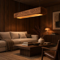 Pendant light shaped as a long wood beam with a warm glowing underside in an evening living room with walnut wall paneling