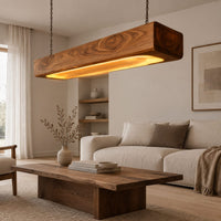 Pendant light shaped as a long wood beam with a warm glowing underside in a Scandinavian living room with white walls