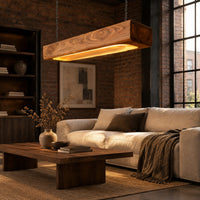 Pendant light shaped as a long wood beam with a warm glowing underside in an industrial loft living room with exposed brick