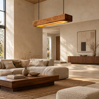 Pendant light shaped as a long wood beam with a warm glowing underside in a bright open plan living room