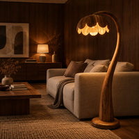 Floor lamp with a flower petal shade on a slender arching stem in an evening living room with walnut wall paneling