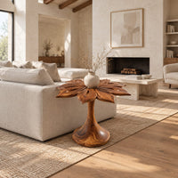 End table with a carved petal top on a flaring trumpet shaped pedestal in a bright open plan living room