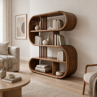 Pill shaped loop bookshelf with slatted dividers and open shelves in a Scandinavian living room with white walls
