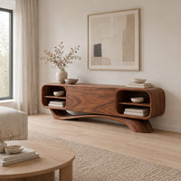 Low pill shaped media cabinet with open end shelves on a sweeping wave base in a Scandinavian living room with white walls