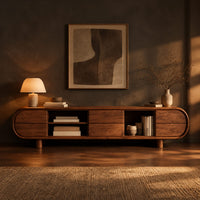 Pill shaped tv stand with open shelf bays and panel fronts in a dark living room at golden hour