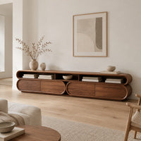 Pill shaped tv stand with three open top bays and two lower cabinets in a Scandinavian living room with white walls