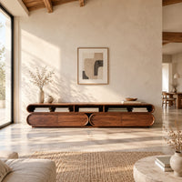 Pill shaped tv stand with three open top bays and two lower cabinets in a bright open plan living room