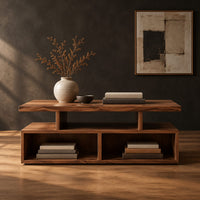 Coffee table with a raised slab top over two open cubbies in a dark studio against a charcoal plaster wall