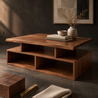 Corner detail of coffee table with a raised slab top over two open cubbies beside wood, brass and linen samples