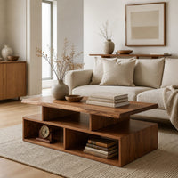 Coffee table with a raised slab top over two open cubbies in a Scandinavian living room with white walls
