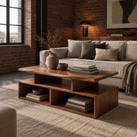 Coffee table with a raised slab top over two open cubbies in an industrial loft living room with exposed brick