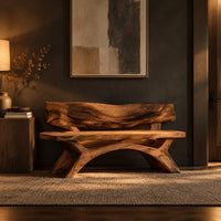 Bench with a live edge slab back, a flat slab seat and arched legs in a dark entryway at golden hour