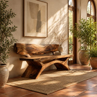 Bench with a live edge slab back, a flat slab seat and arched legs in a bright entryway with arched windows and plants