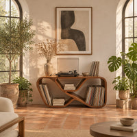 Low record console with a looping ribbon frame and open end bays in a bright living room with arched windows and plants