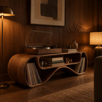 Long low record console with rolled ends and a wave shaped lower edge in an evening living room with walnut wall paneling