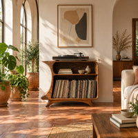 Flared record stand with a small upper bay and a larger open bay below in a bright living room with arched windows and plants