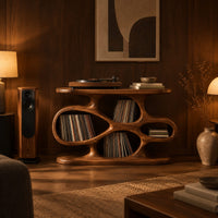 Sculpted record player stand with flowing open cutouts and a flat top in an evening living room with walnut wall paneling