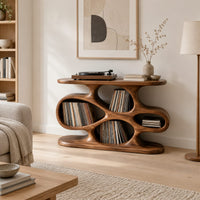 Sculpted record player stand with flowing open cutouts and a flat top in a Scandinavian living room with white walls