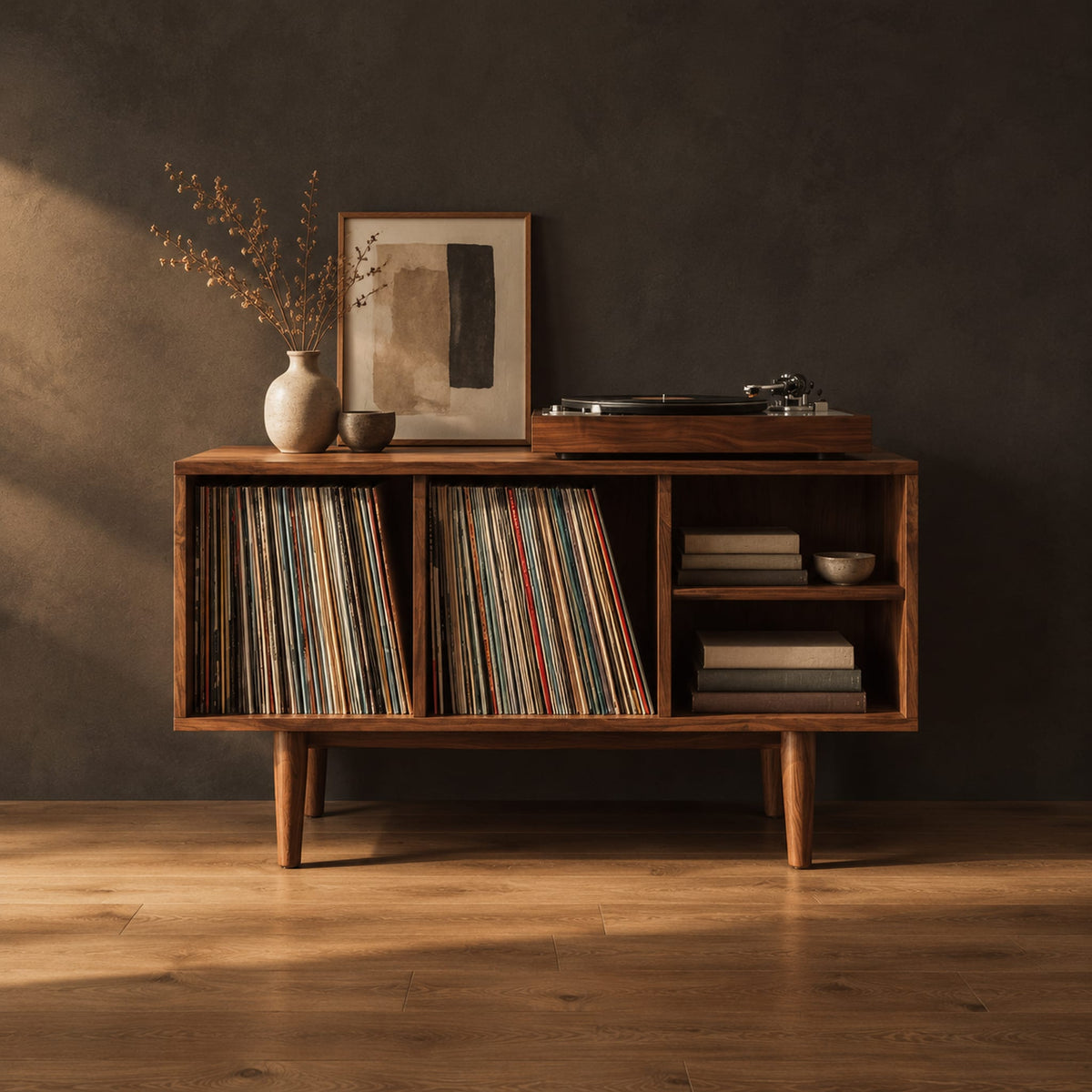 Open record player stand with four bays on tapered legs in a dark studio against a charcoal plaster wall