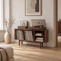 Open record player stand with four bays on tapered legs in a Scandinavian living room with white walls