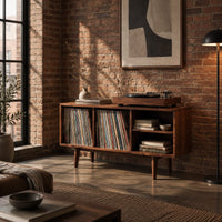 Open record player stand with four bays on tapered legs in an industrial loft living room with exposed brick