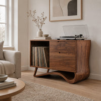 Record player stand with an open side bay and a sweeping ribbon base in a Scandinavian living room with white walls