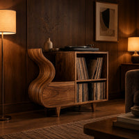 Record player stand with a flowing wave side and two open cubbies in an evening living room with walnut wall paneling